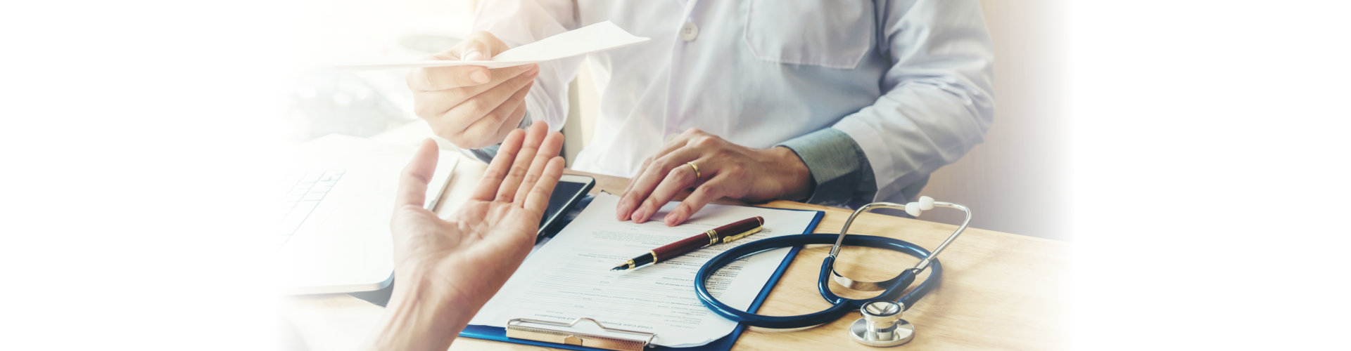 doctor giving prescriptions to a patient