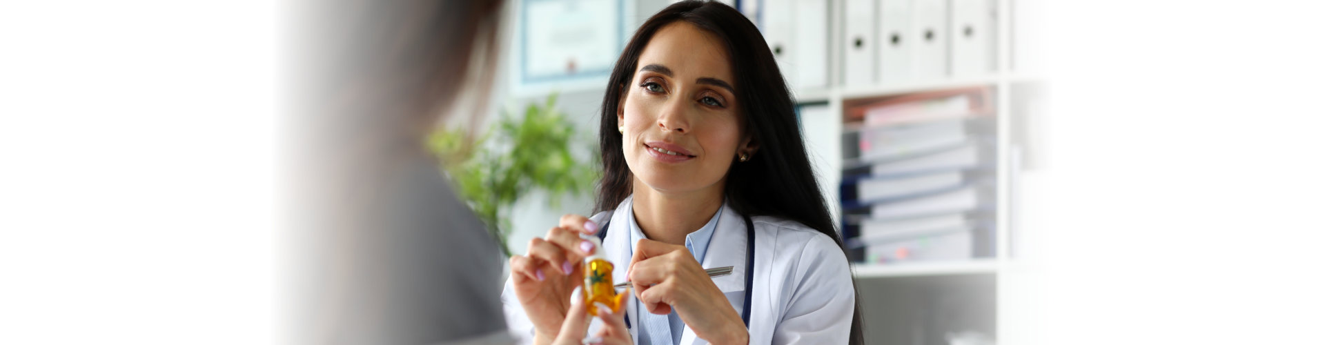 caregiver giving medicine to a patient