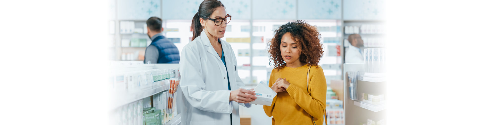 caucasian pharmacist helping beautiful black female customer