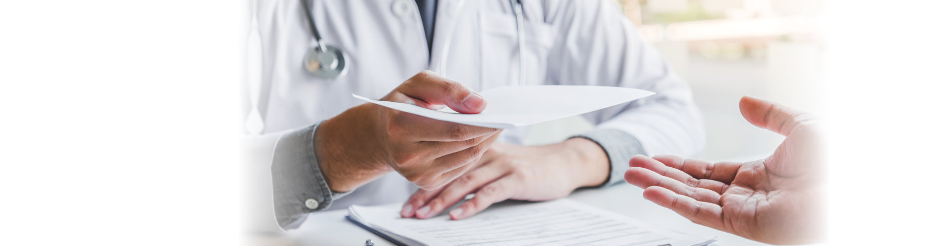 doctor writing diagnosis and giving a medical prescription to a patient