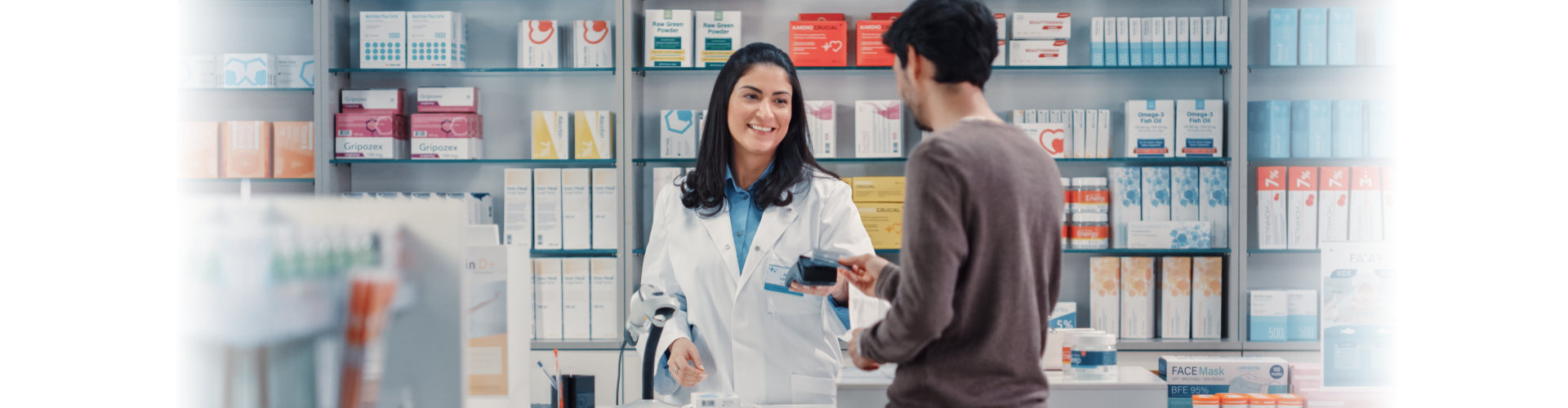 young man at the checkout counter inside the pharmacy